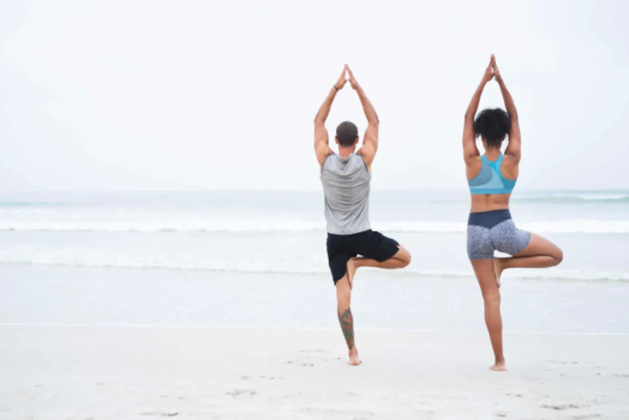 couple doing beach yoga at resort in south carolina